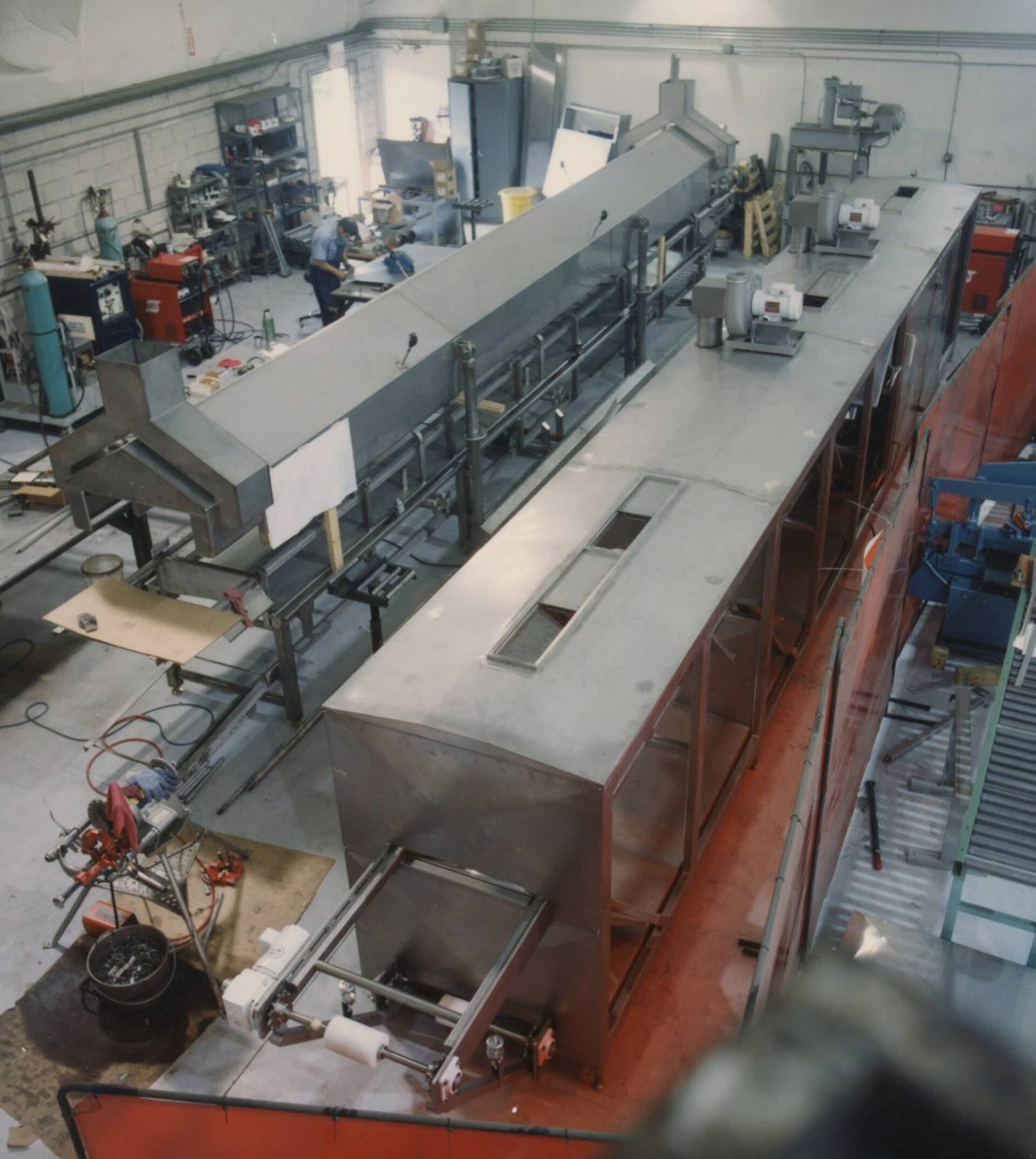 Stainless steel processing equipment on a factory floor